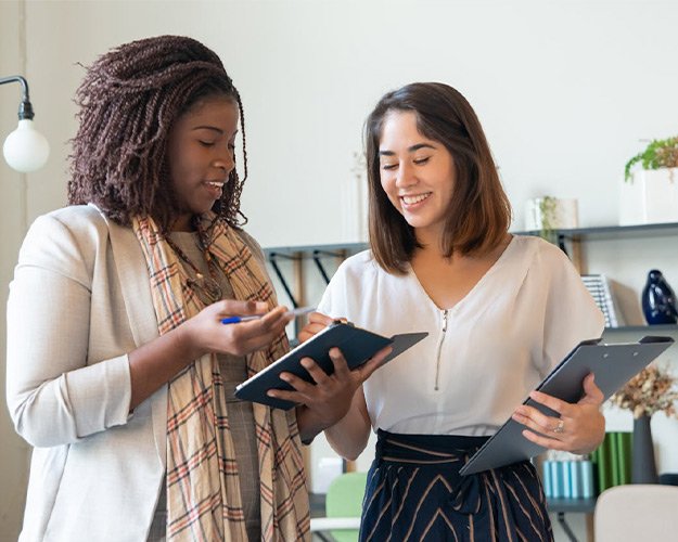 Two professionals reviewing business plans together